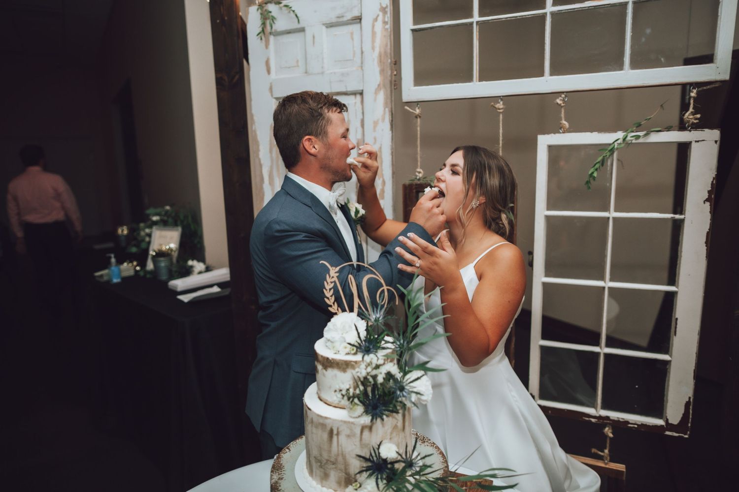 Wedding reception venue decorated with rustic elements and string lighting.