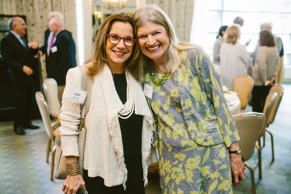 Two attendees sharing a friendly moment at a professional networking event.
