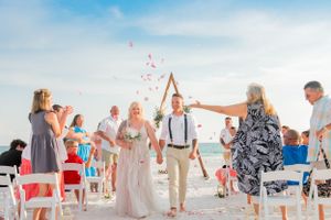 bride and groom walking down the aisle after their beach wedding on Panama City Beach Florida