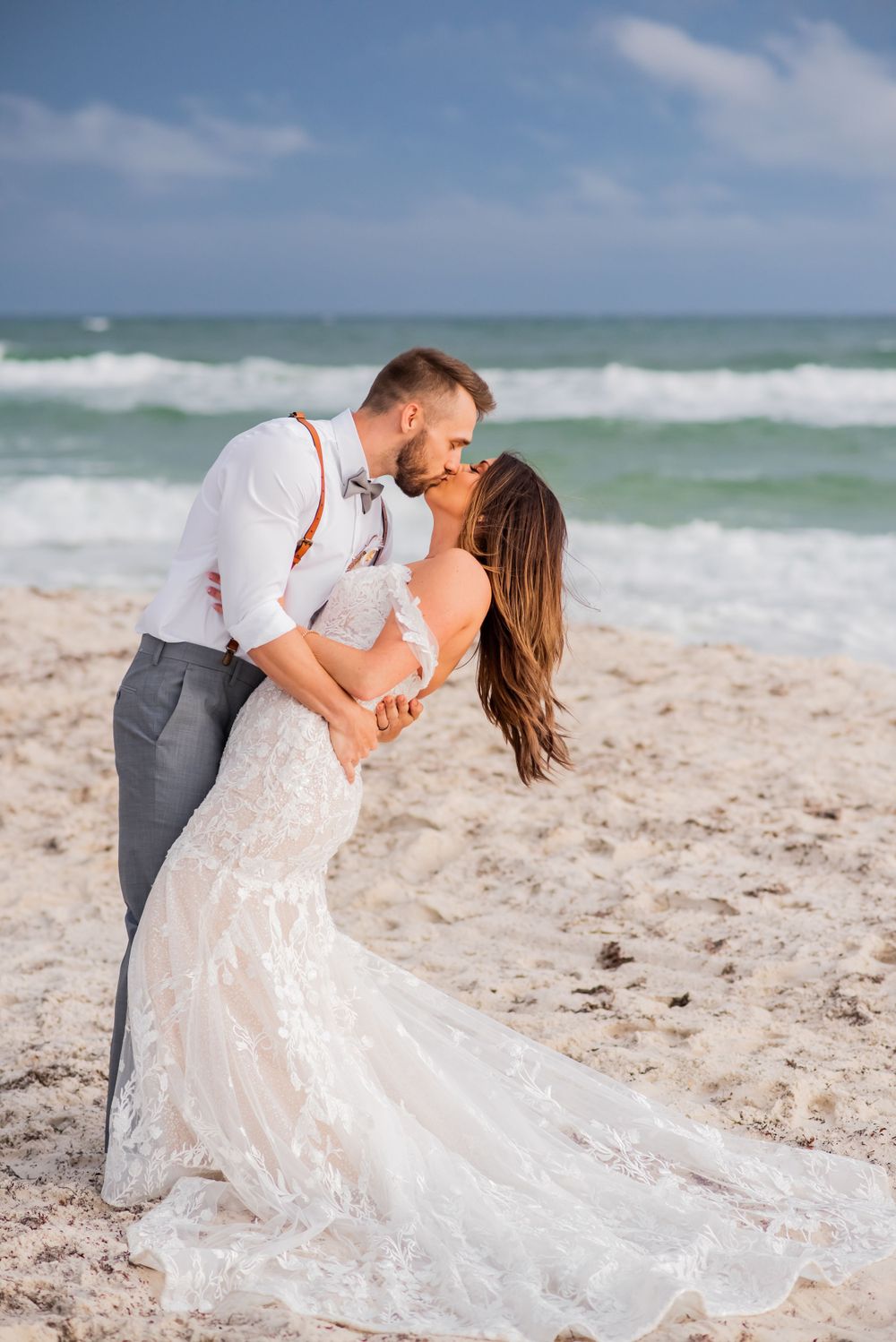bride & groom kissing & dancing on the beach at sunset on their wedding day on Panama City Beach Florida