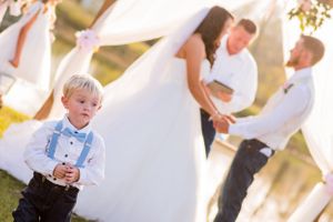 ringbearer in front of bride and groom during their wedding in Panama City Florida