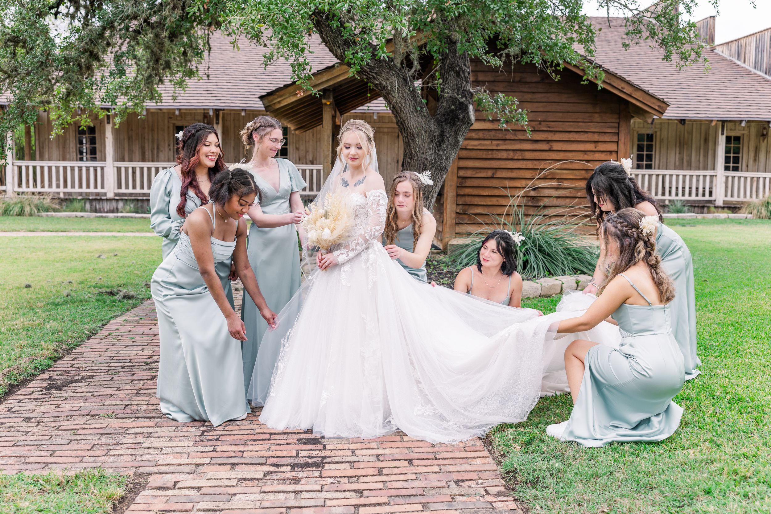 bridesmaids helping bride with dress