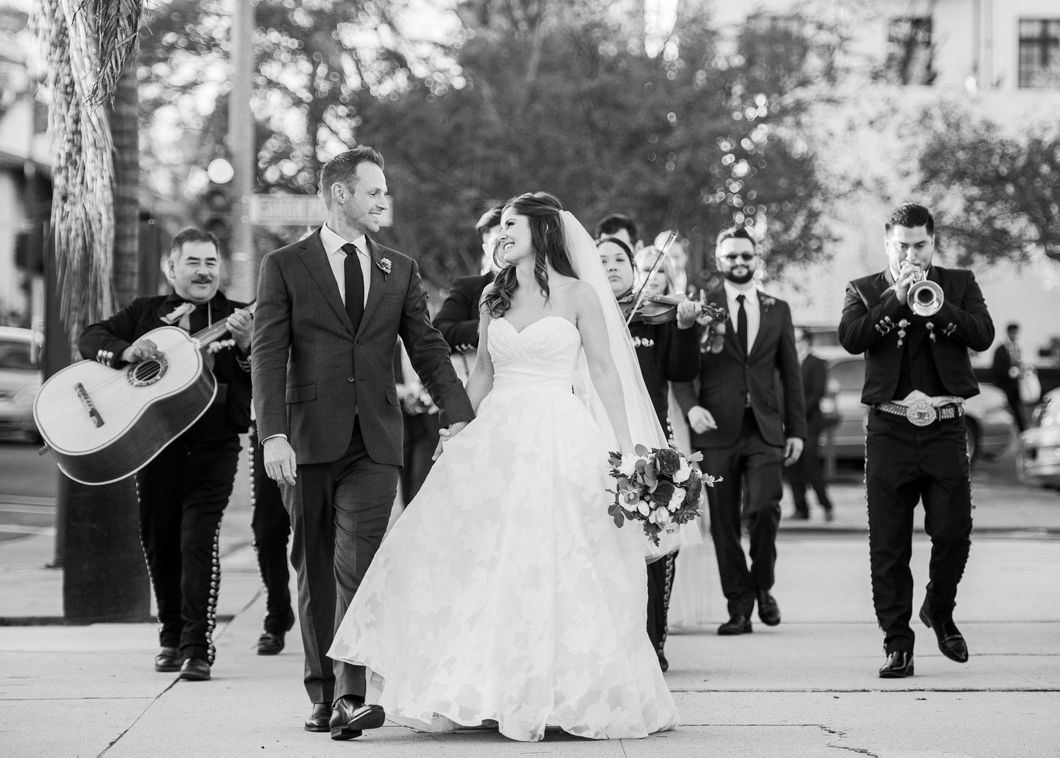 wedding couple with mariachi band playing behind them in santa barbara ca