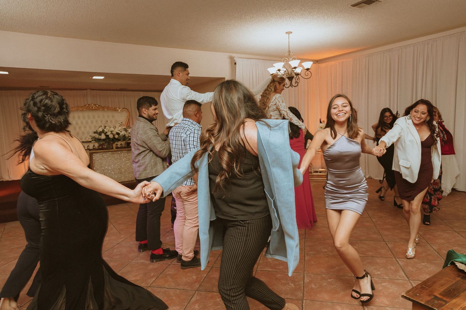 Energetic group dancing and celebrating together at an indoor party venue.