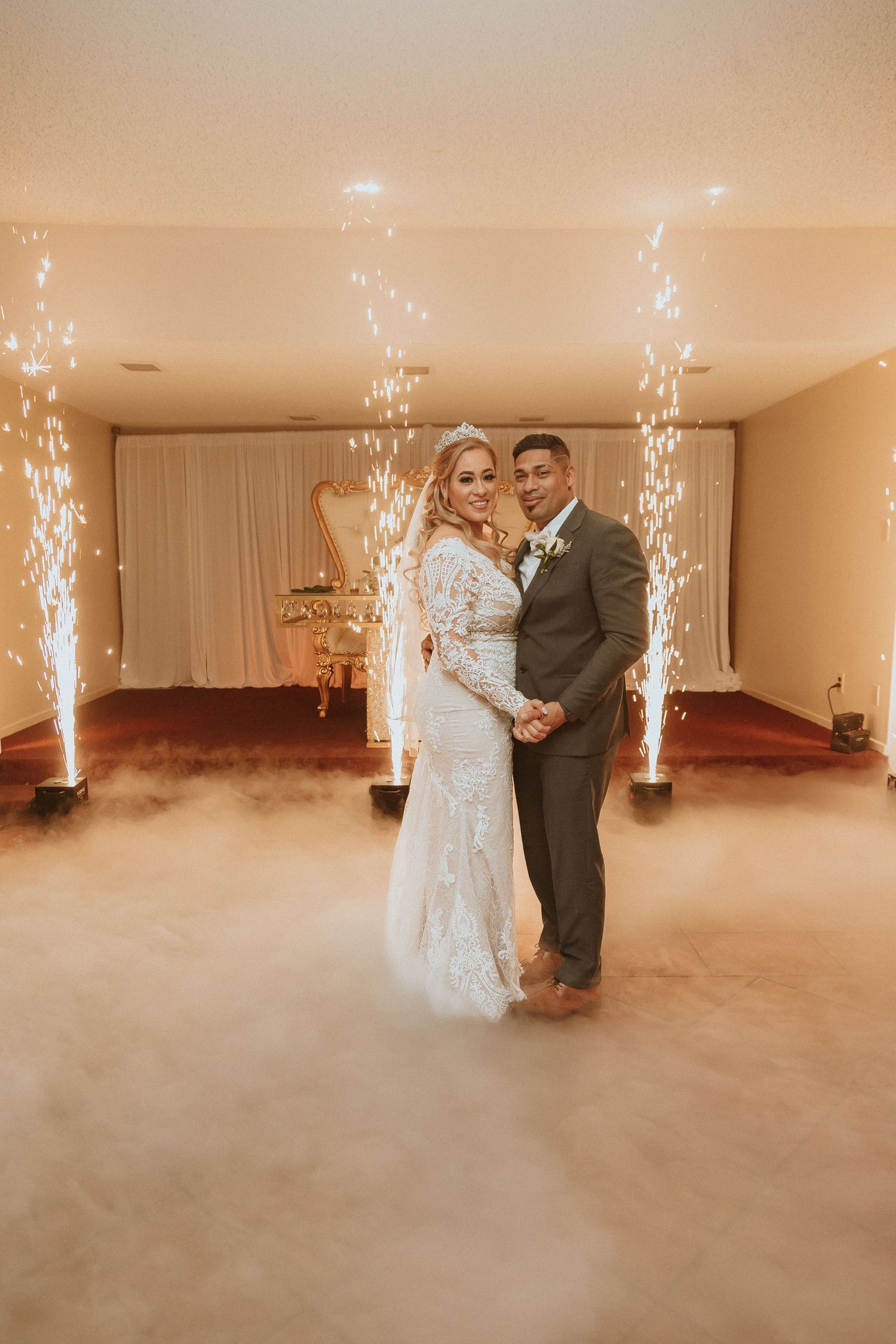 A romantic wedding scene with indoor pyrotechnics and fog machines creating a dreamy atmosphere.