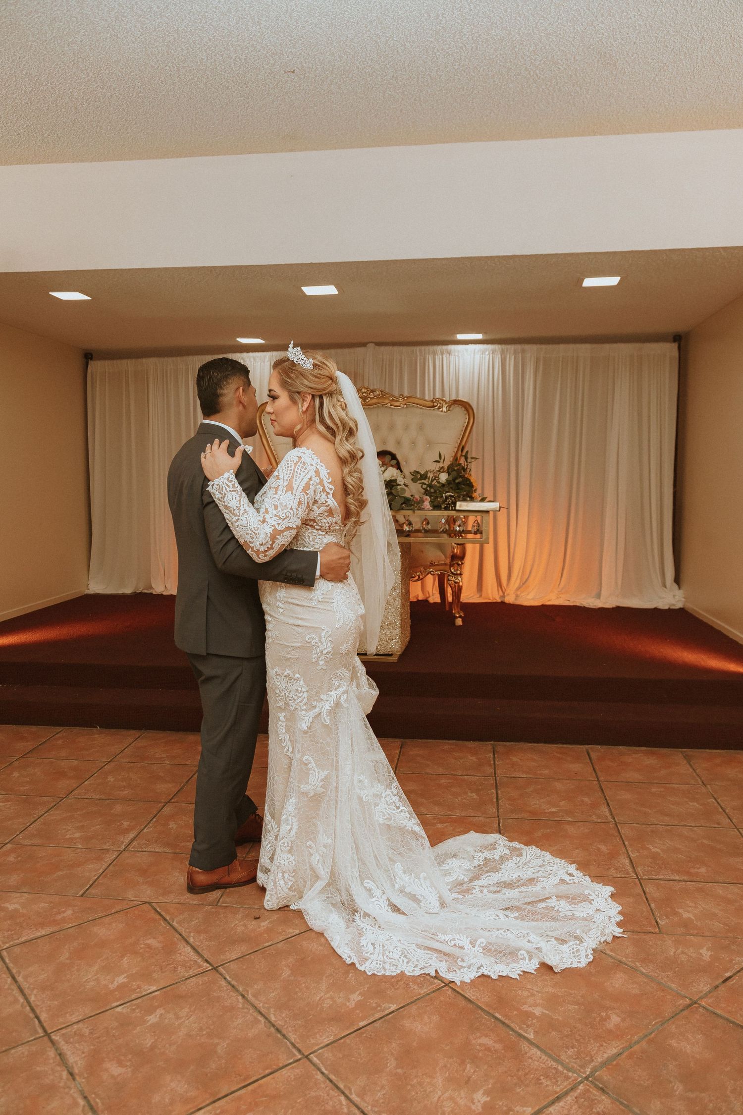 A couple embraces during an intimate dance moment at their wedding reception.