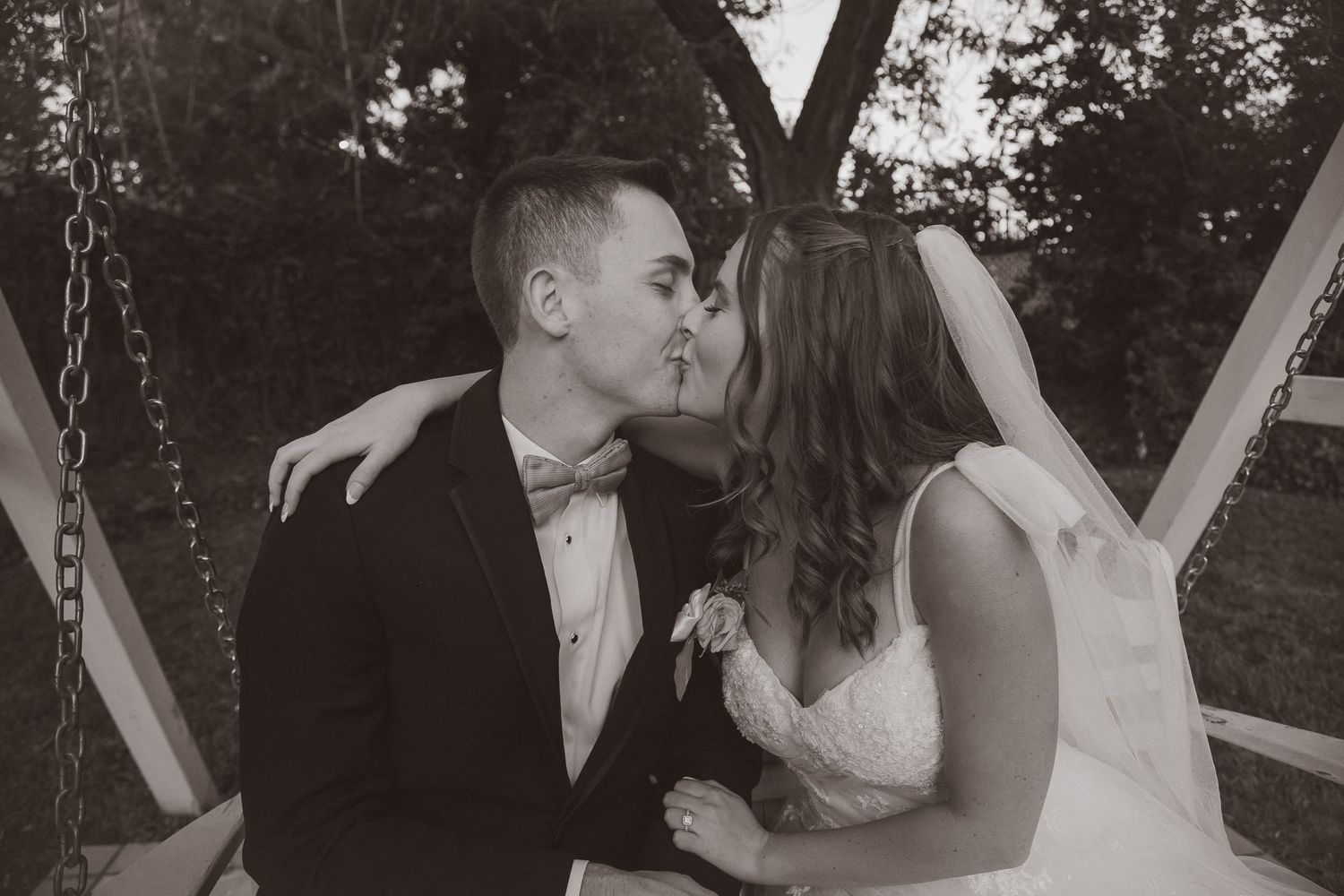 Classic black and white wedding portrait showing intimate moment between couple.