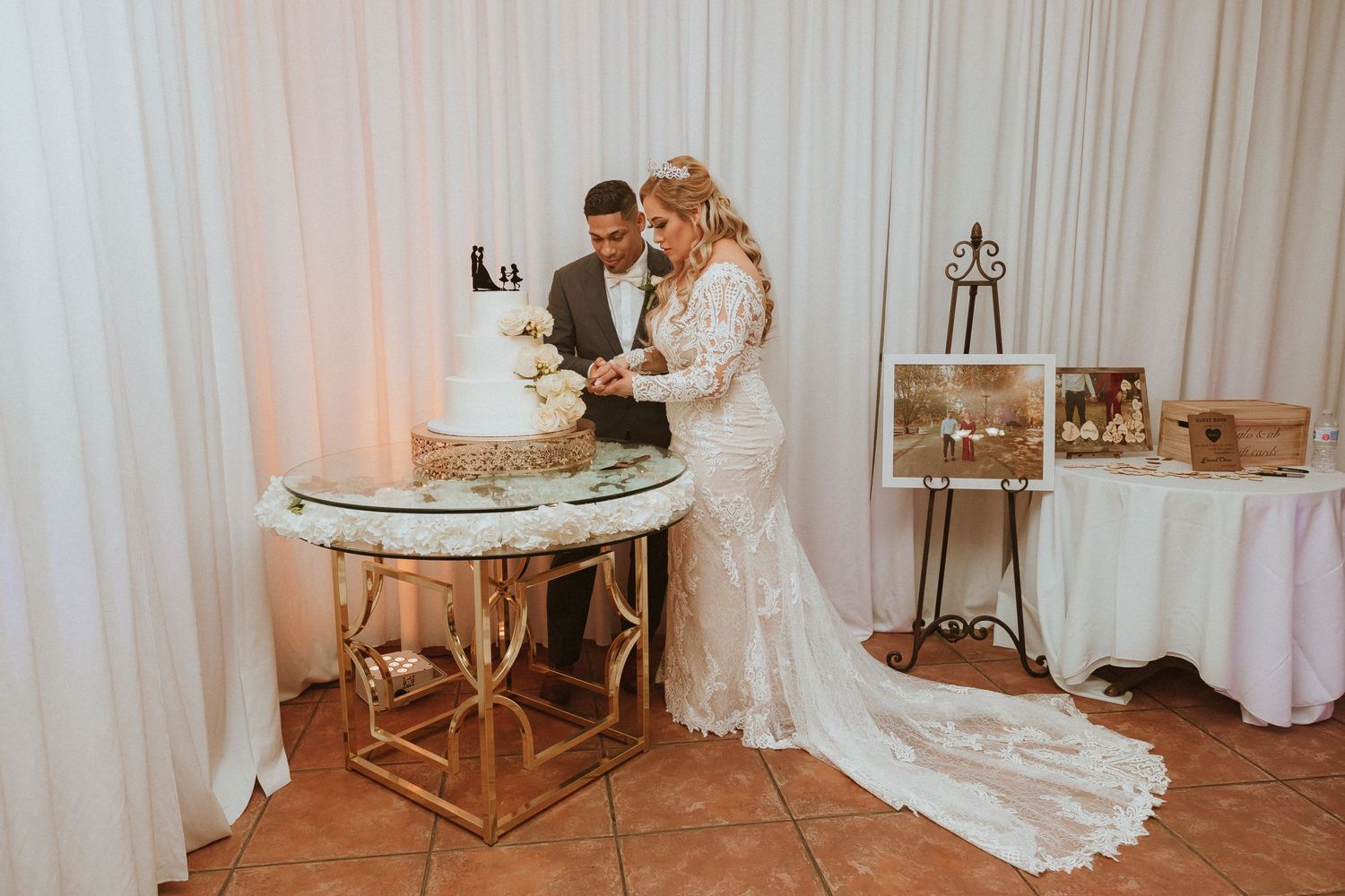 Couple shares intimate moment while cutting their wedding cake at reception.
