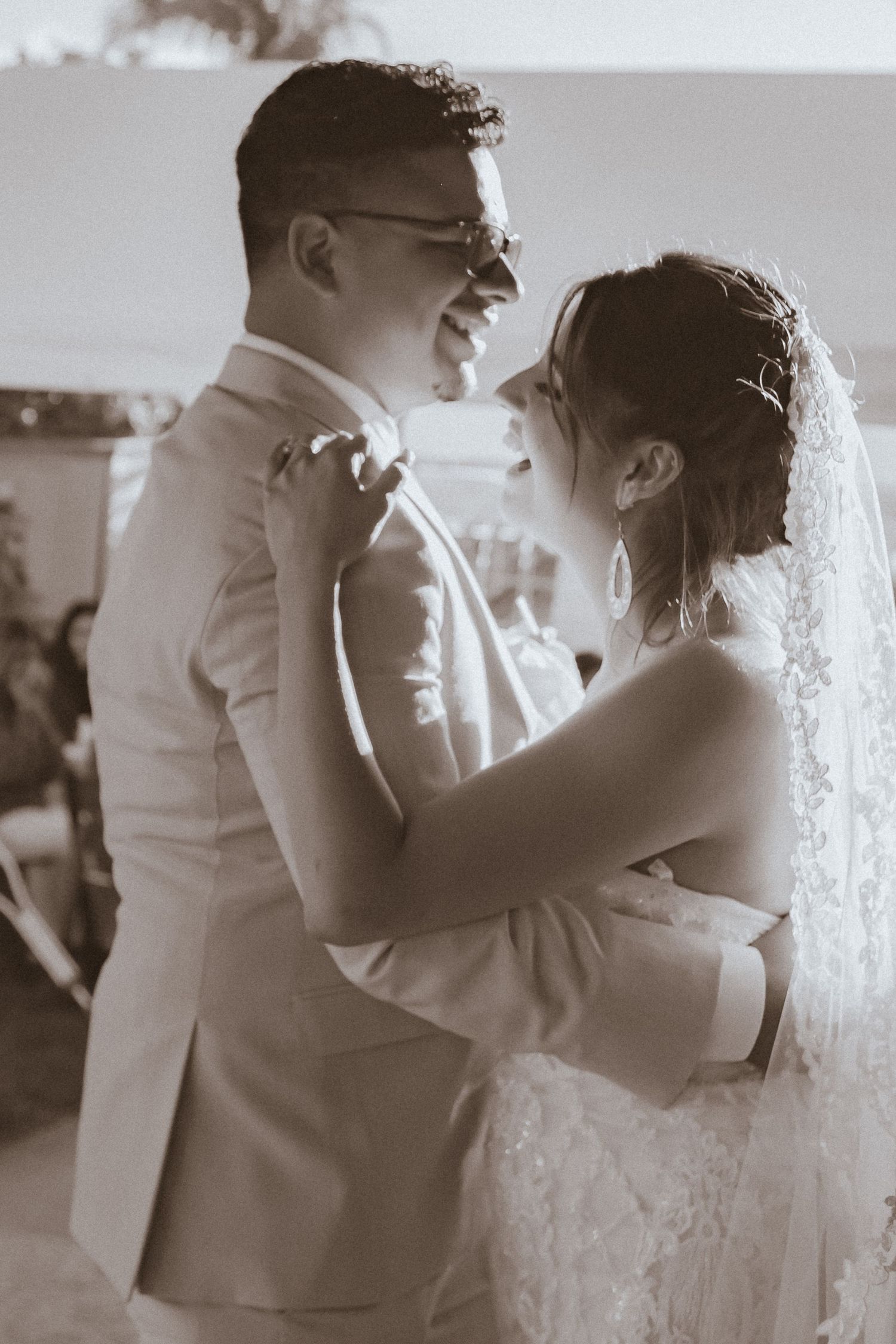 A tender black and white moment of newlyweds sharing their first dance at their wedding reception.