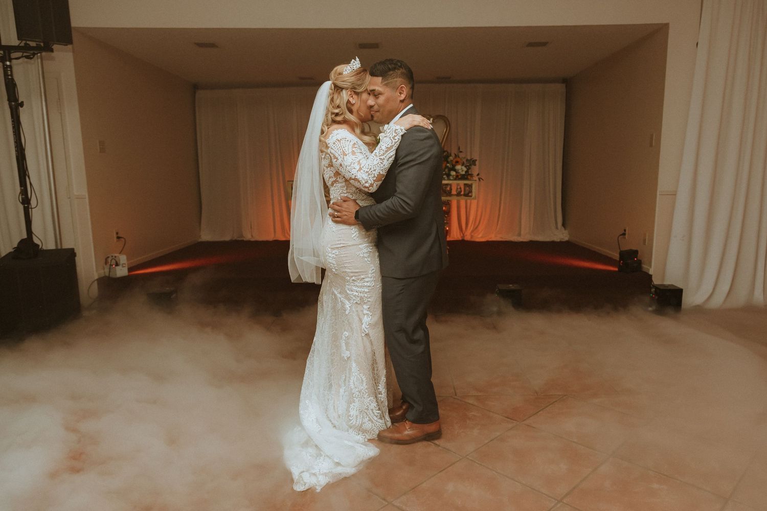 Intimate wedding dance moment captured in warm vintage tones with romantic lighting.