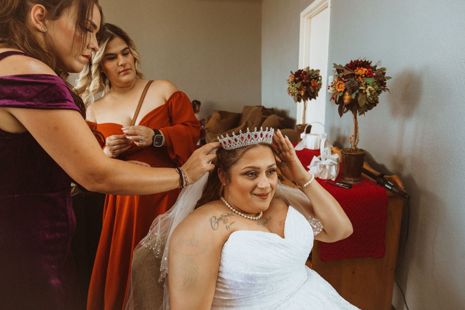 Wedding preparations show attendants helping with final touches before the ceremony.
