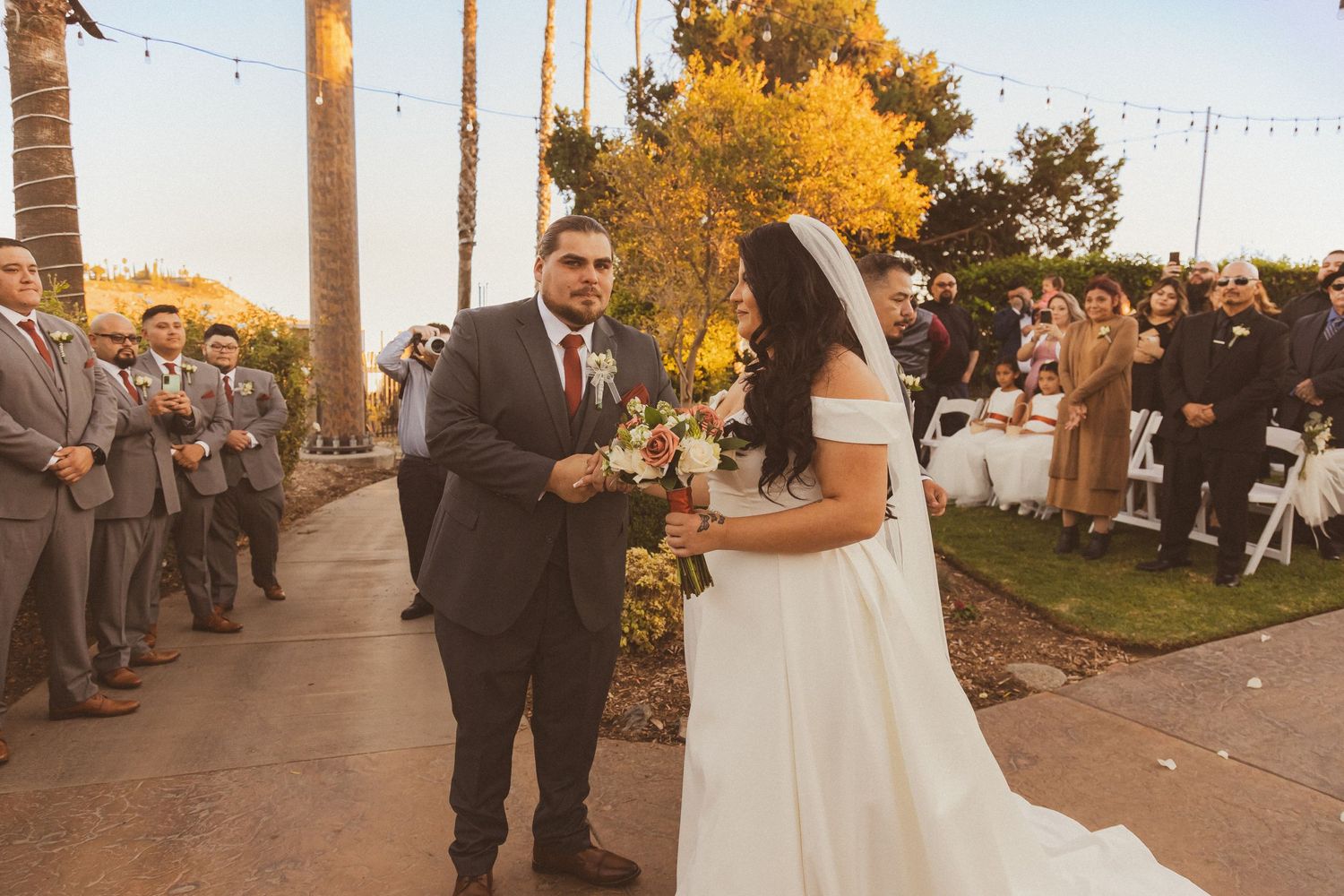 A wedding couple shares their first moments together during their outdoor autumn ceremony.