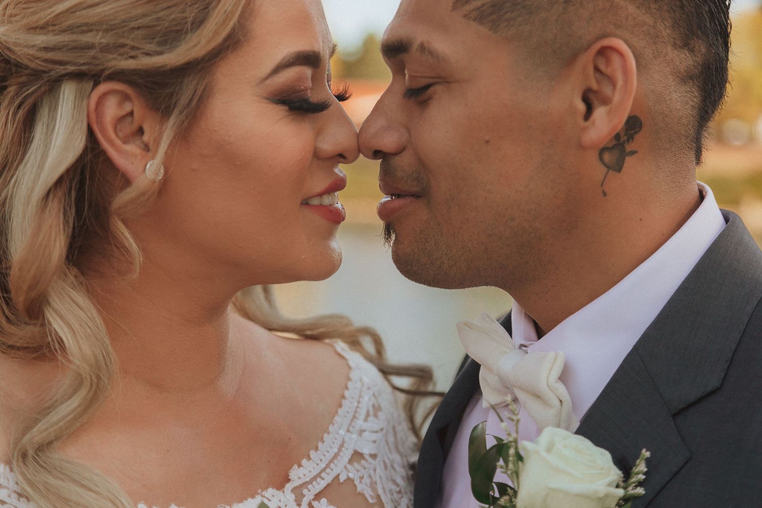Close-up romantic wedding portrait showcasing elegant bridal makeup and jewelry.