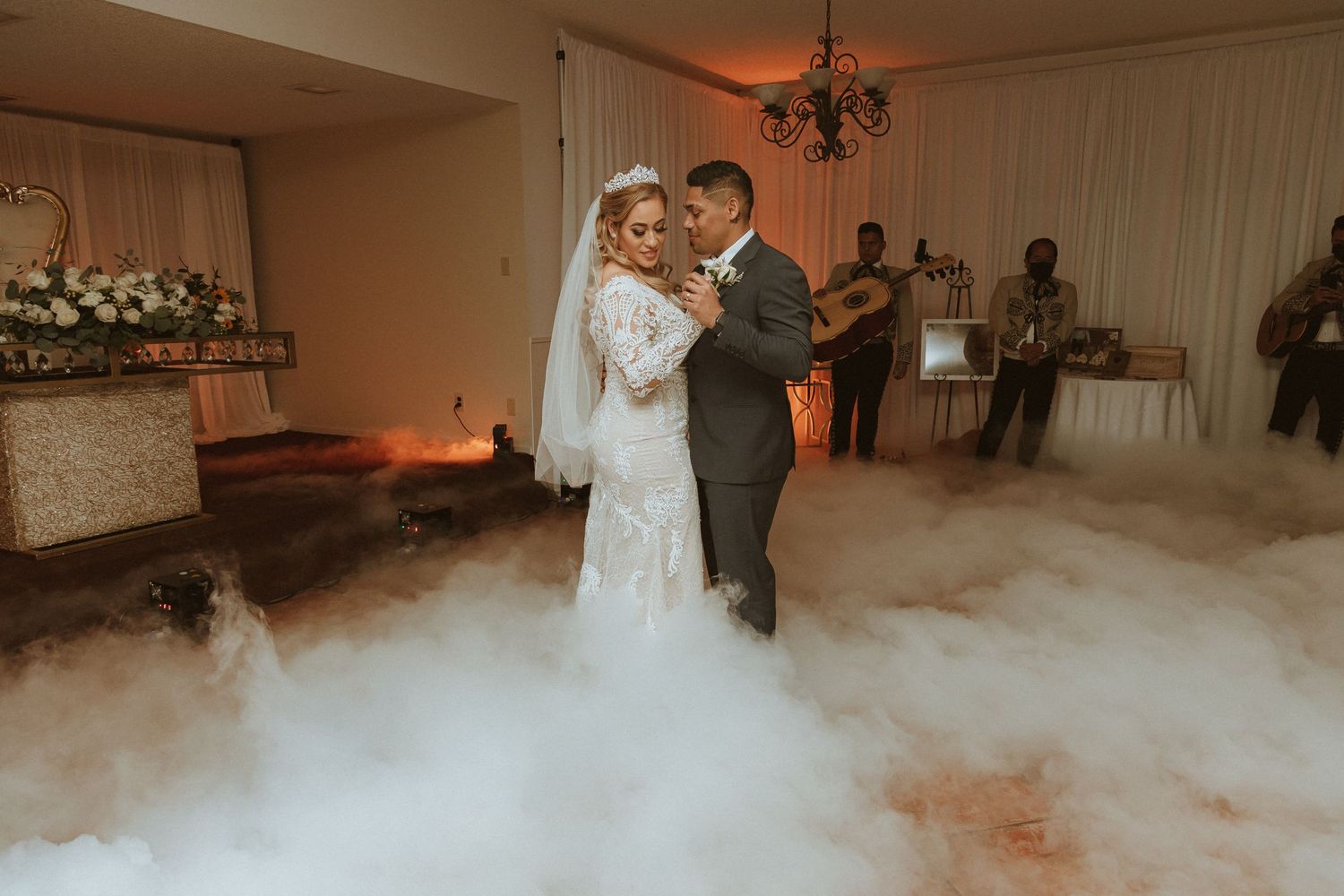 First dance on a misty dance floor with romantic lighting and decorative smoke effects.