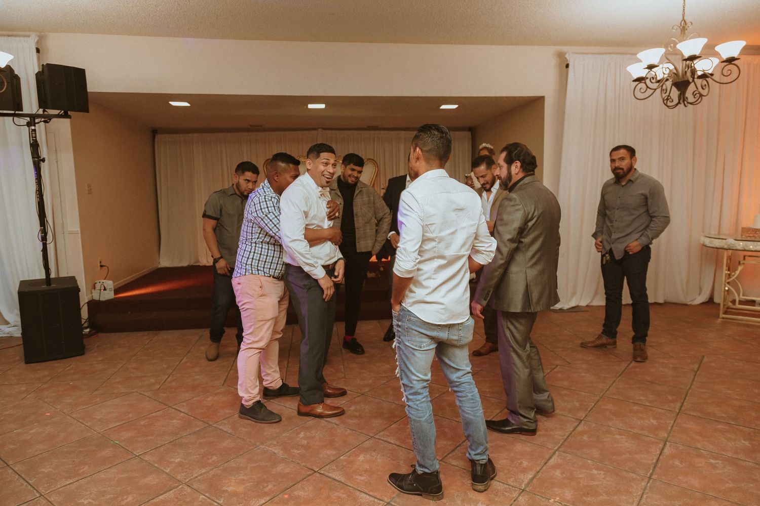 Group of wedding guests gathered in casual conversation at the reception.