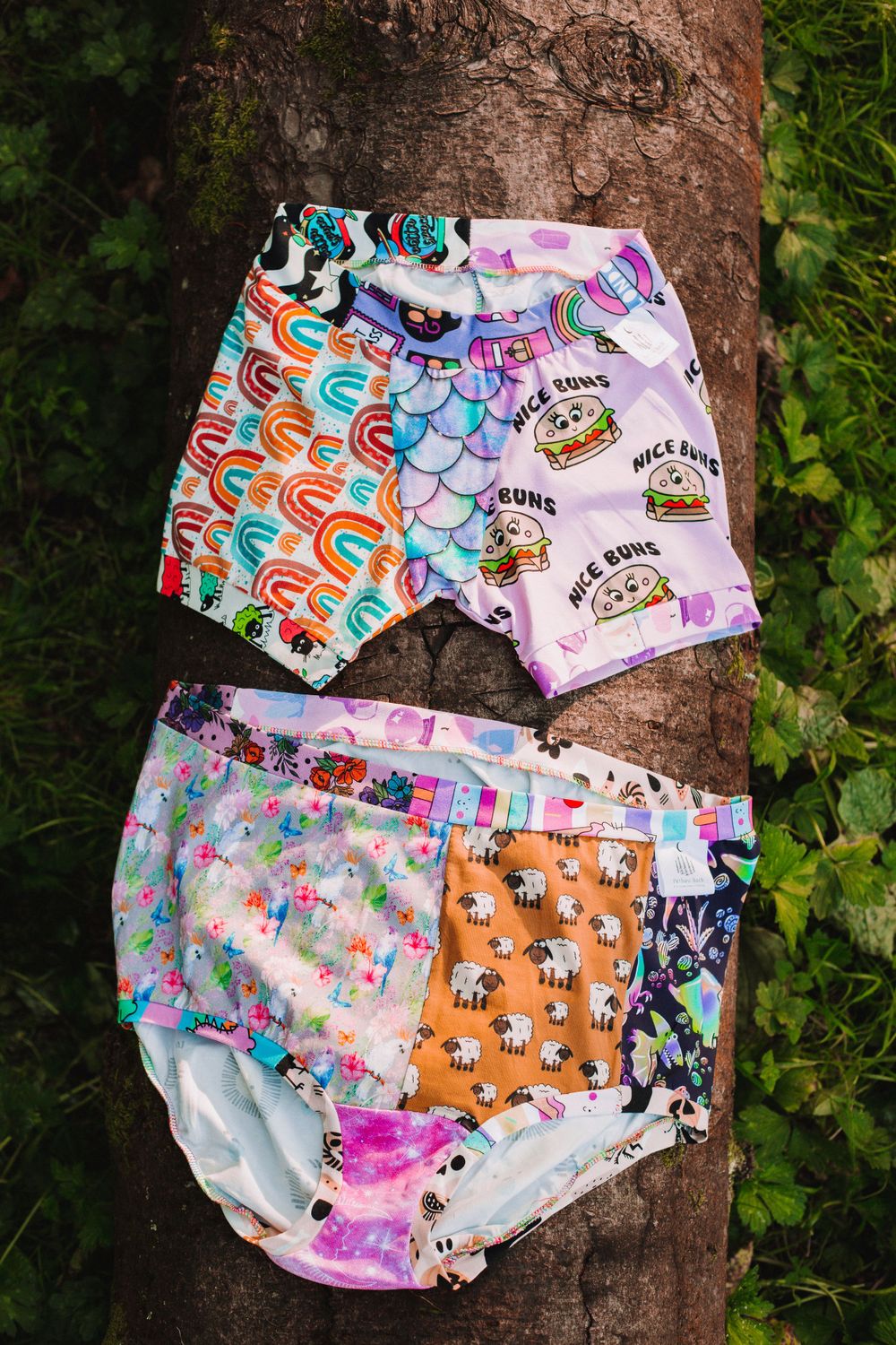 Collection of cute patterned underwear featuring animals and colorful designs displayed on tree bark.