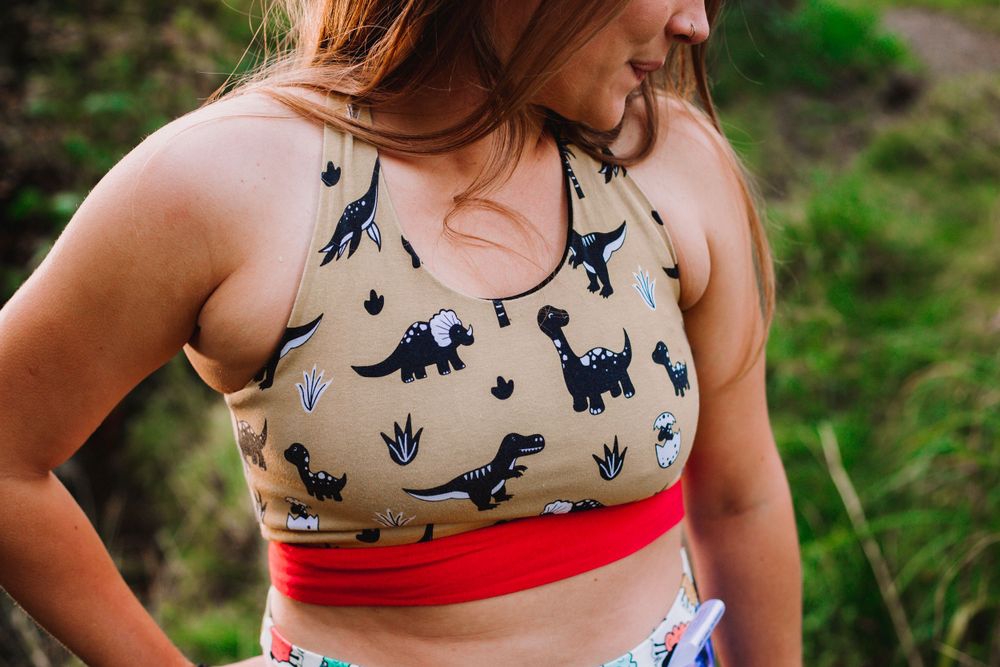 Person wearing patterned bralette with animal designs in outdoor setting.