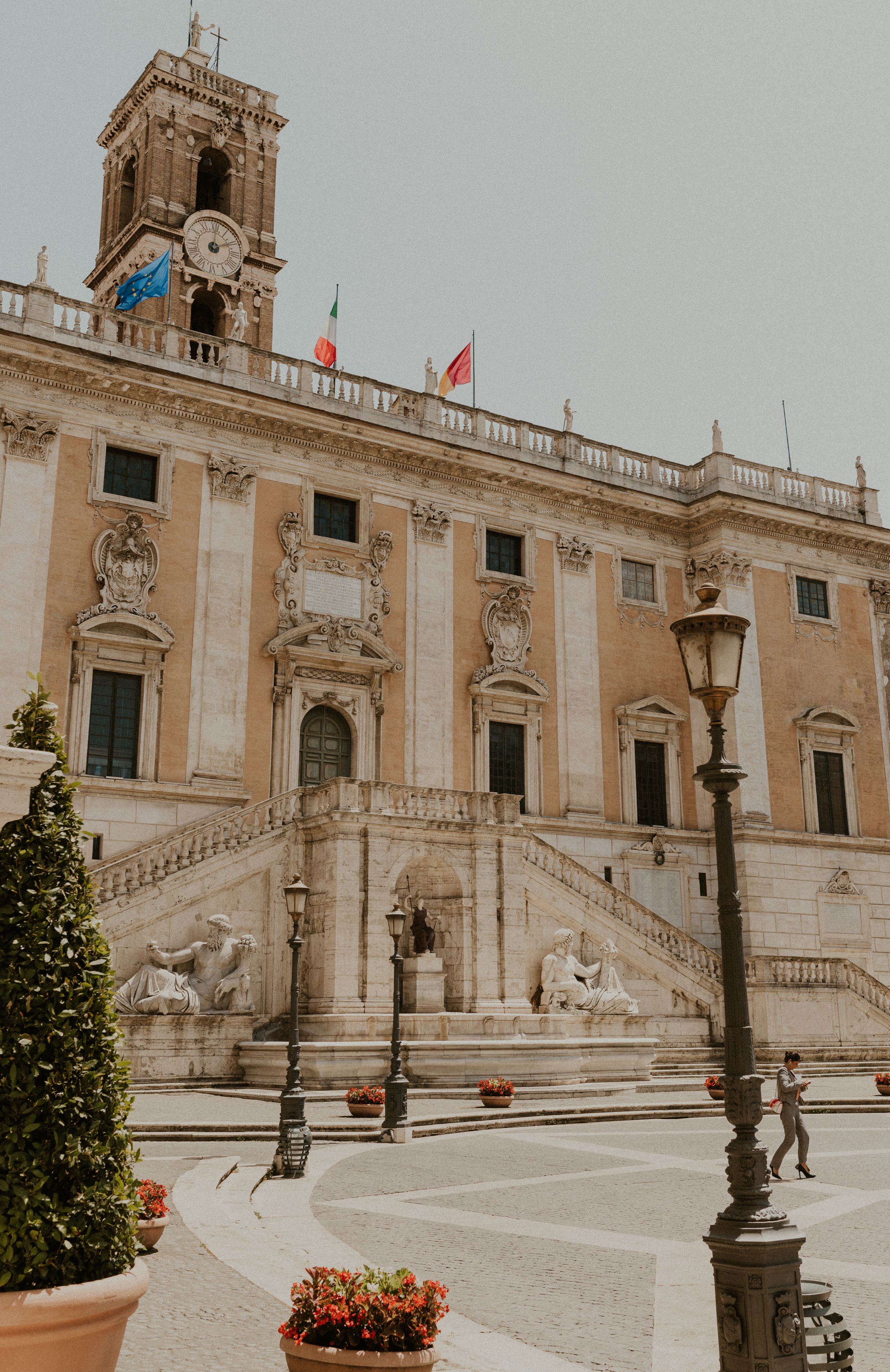 Grand Baroque facade of Capitoline Hill in Rome with ornate staircase and decorative sculptures.