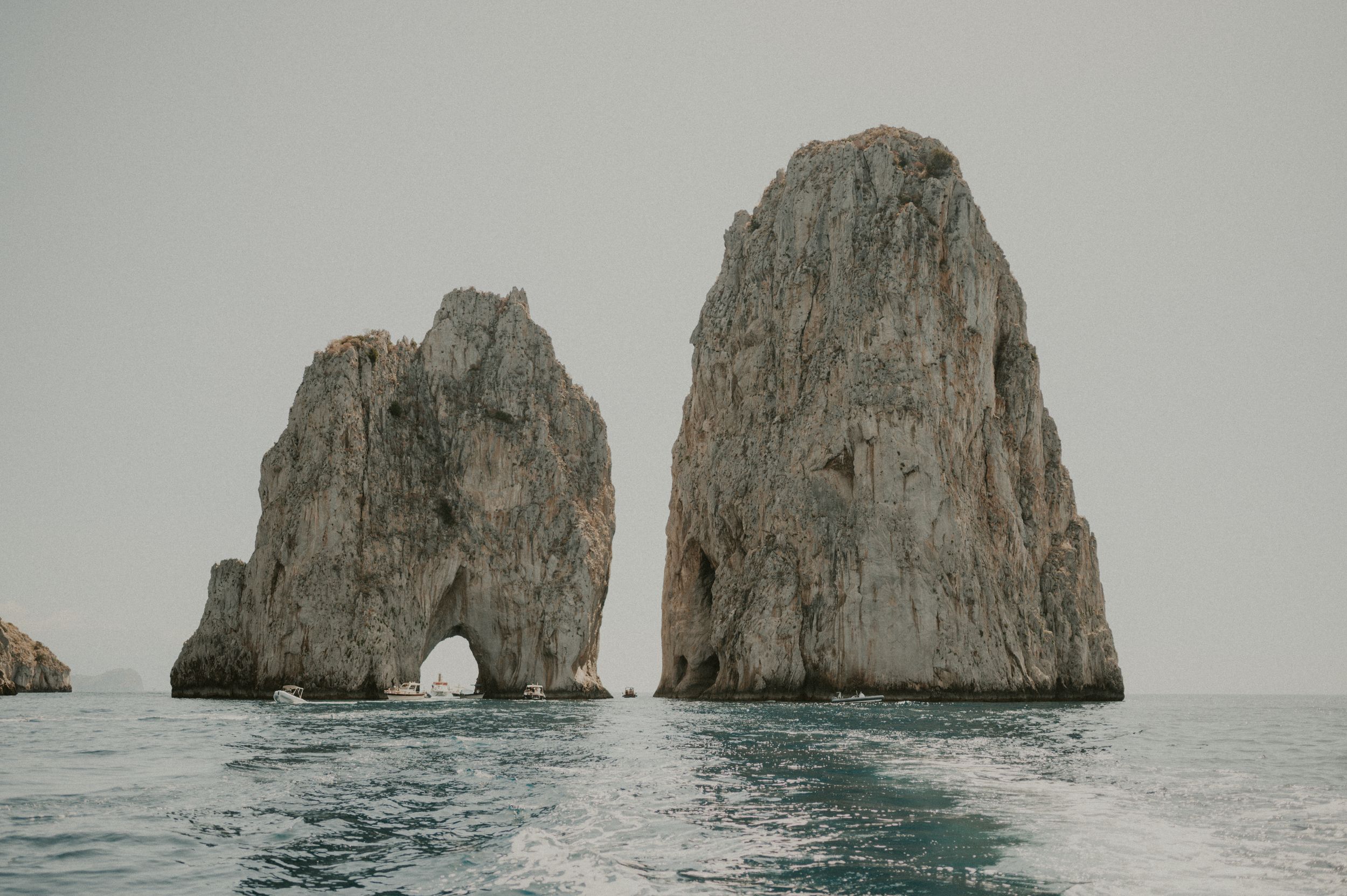 The famous Faraglioni rock formations rising from the sea off the coast of Capri, Italy.