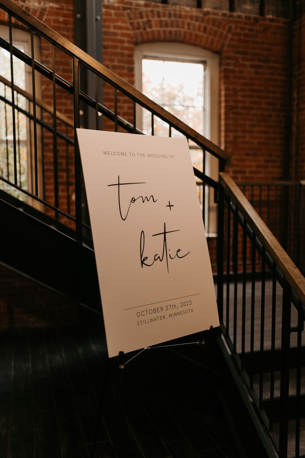 Elegant wedding welcome sign for Tom and Katie, October 2023, Stillwater Minnesota, displayed on easel.