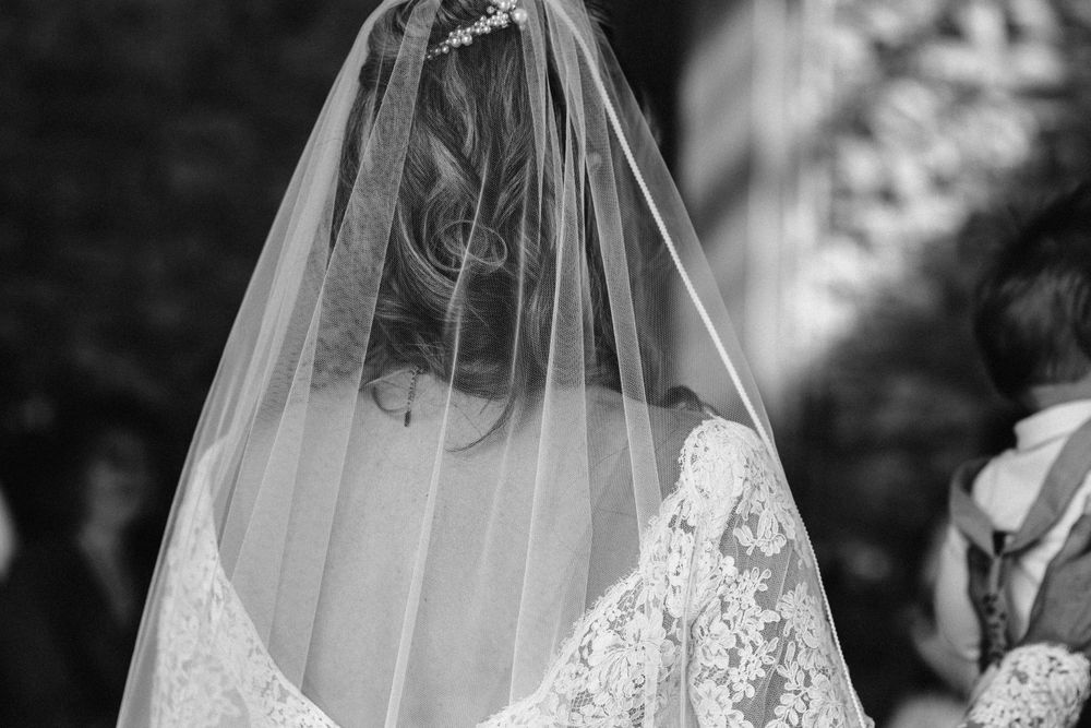 Delicate lace details of a wedding veil captured in black and white.