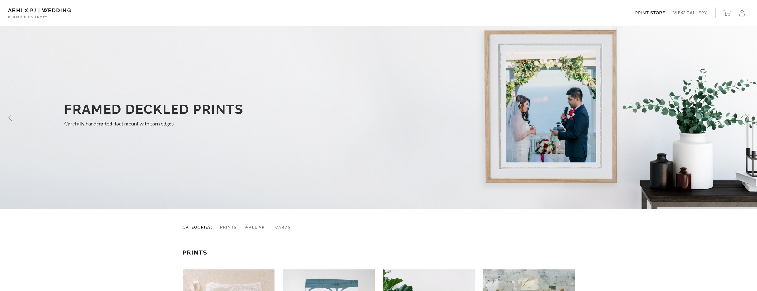 Gallery wall display featuring framed wedding photographs and prints.