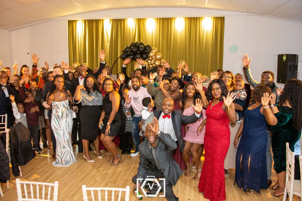 Large group of elegantly dressed guests celebrate together at a formal birthday party.