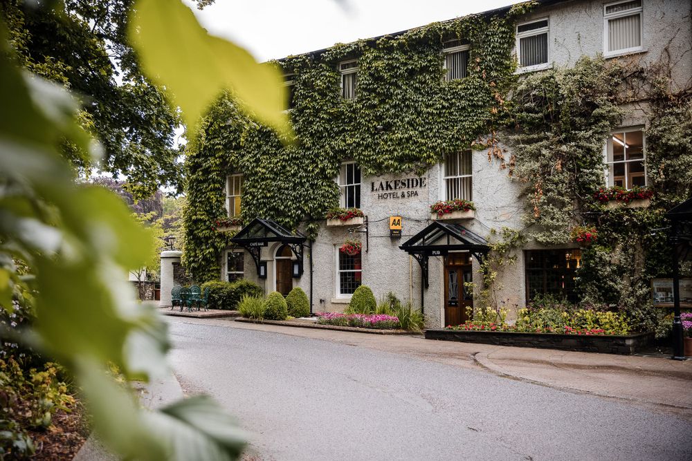 Ivy covered traditional English country inn facade with quaint entrance.