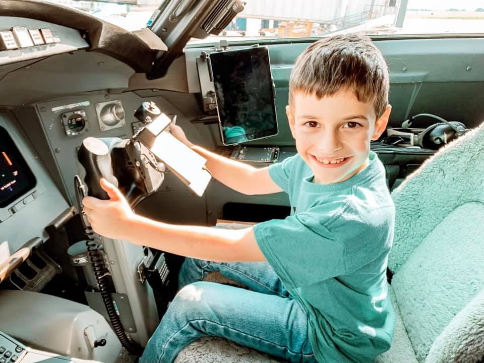 Child in turquoise shirt playing and posing inside a vehicle across multiple candid shots.