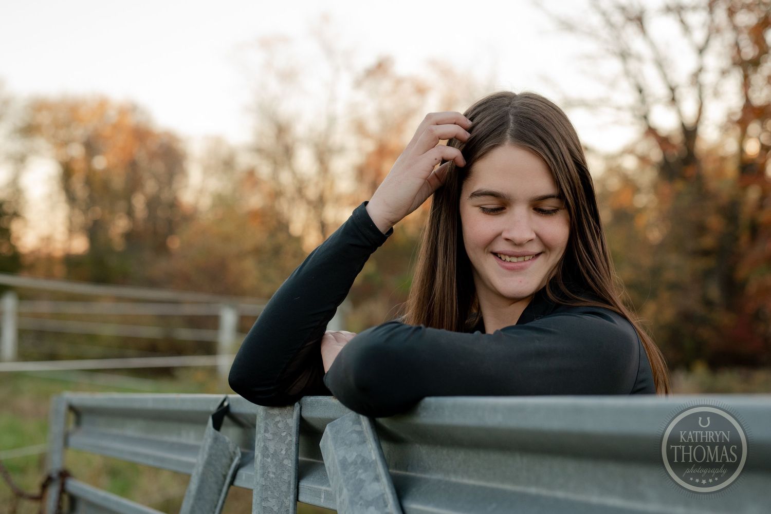 Candid moment captured by metal fence during golden hour.