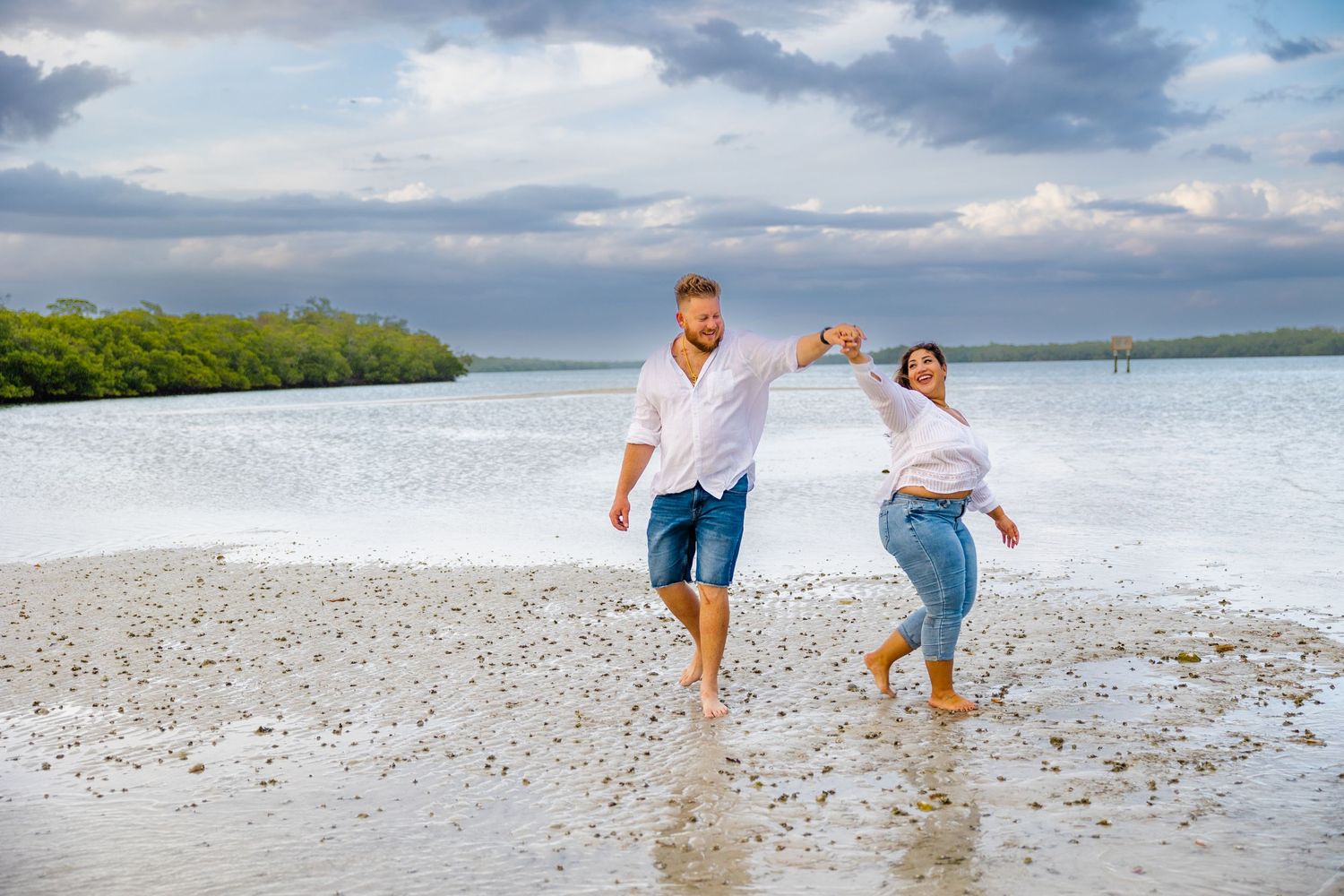 happy couple dancing on the beach