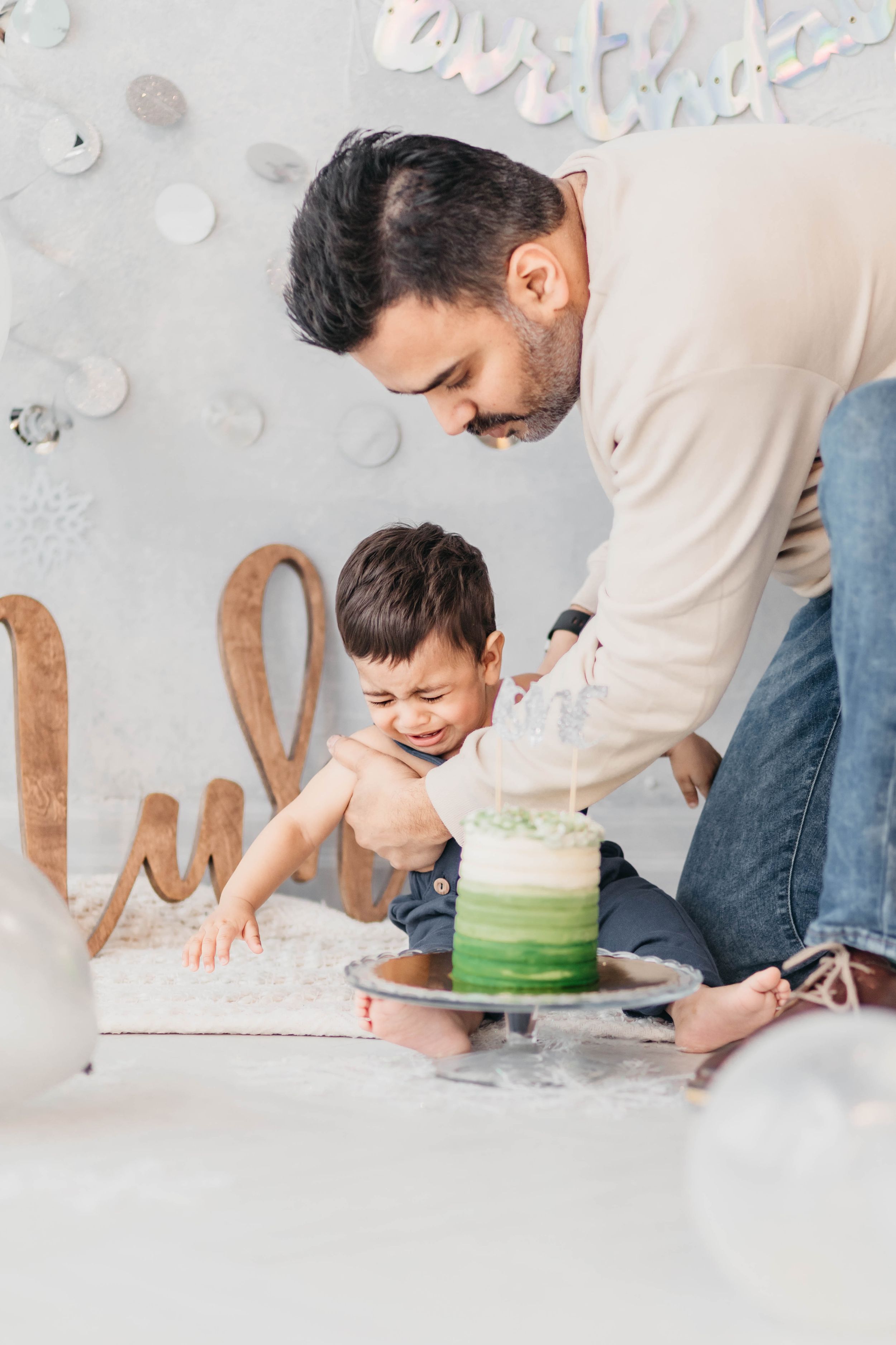 A special birthday moment shared while decorating a green ombre cake.