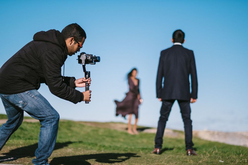 Film Drop on a gimbal shooting a Sri Lankan tamil couple facing each other for a pre wedding shoot at Watsons Bay
