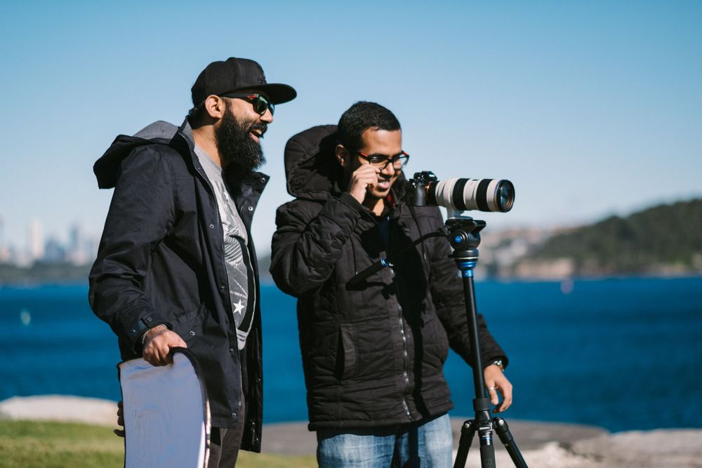 Jana and Saieash looking at a camera doing a pre wedding shoot in Watsons Bay Sydney for a Sri Lankan Tamil couple