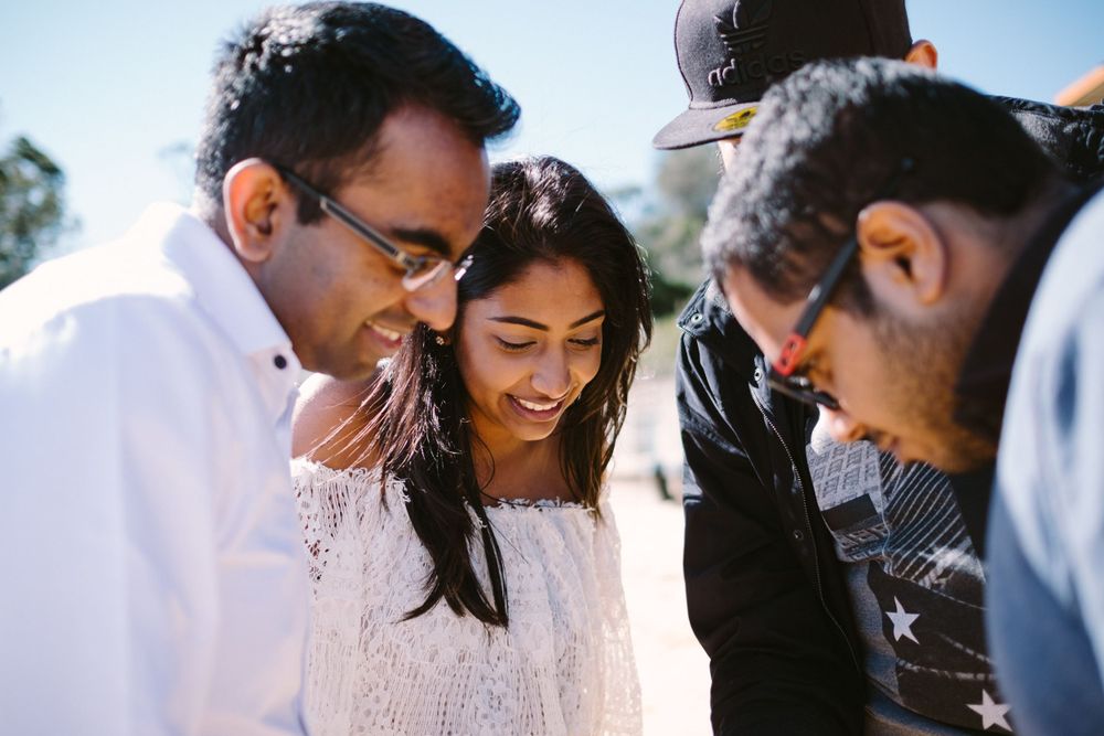 A Sri Lanakan Tamil couple reviewing the shots with Film Drop at their pre wedding shoot in Watsons Bay