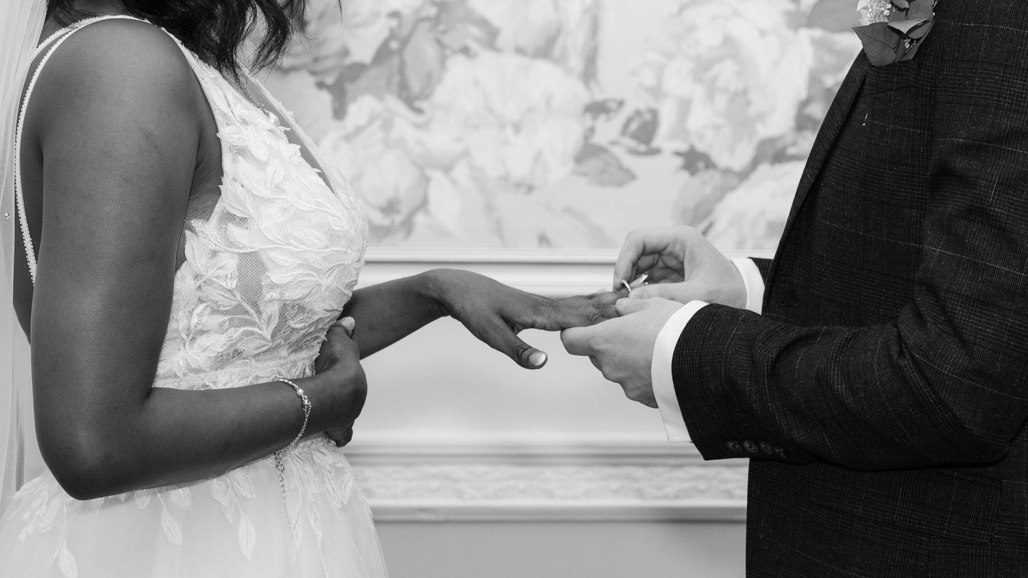 Groom placing the wedding ring on his wifes finger. Basingstoke registry Office, Hampshire