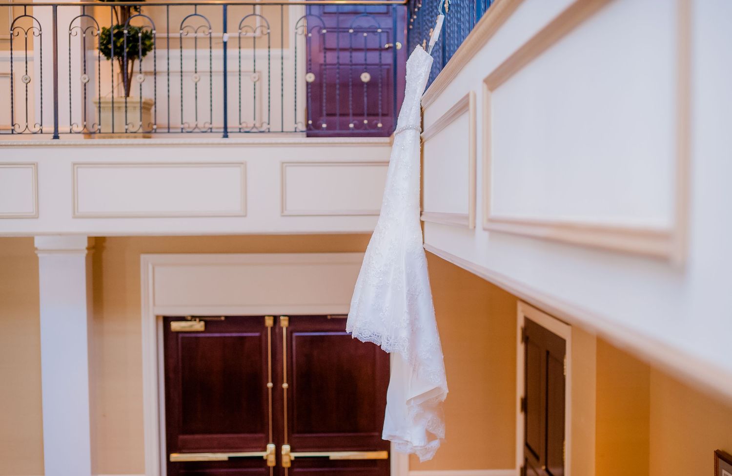 Elegant interior hallway with ornate white moldings and crystal chandelier.