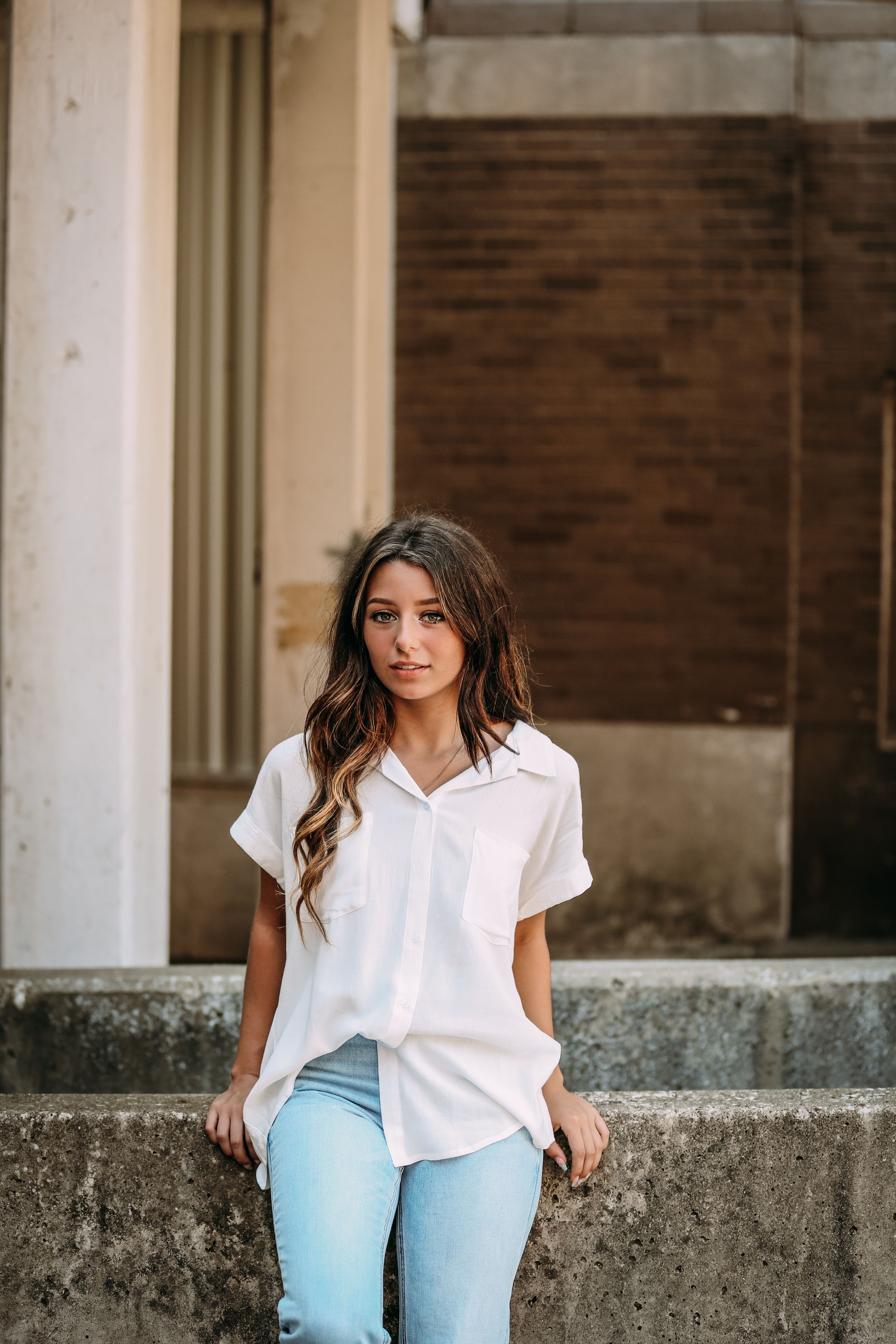 girl leaning against bridge