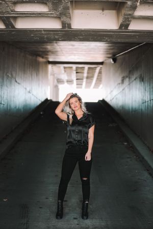 girl in dark clothes in dark tunnel