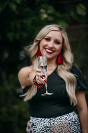 girl holding out champagne glass