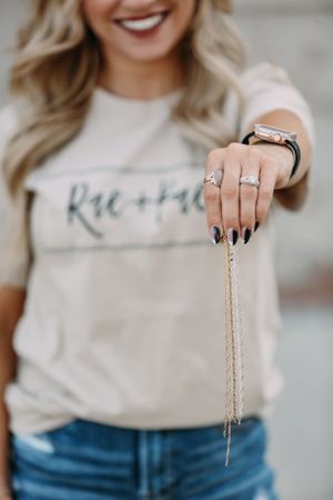 detail of girl holding permanent jewelry