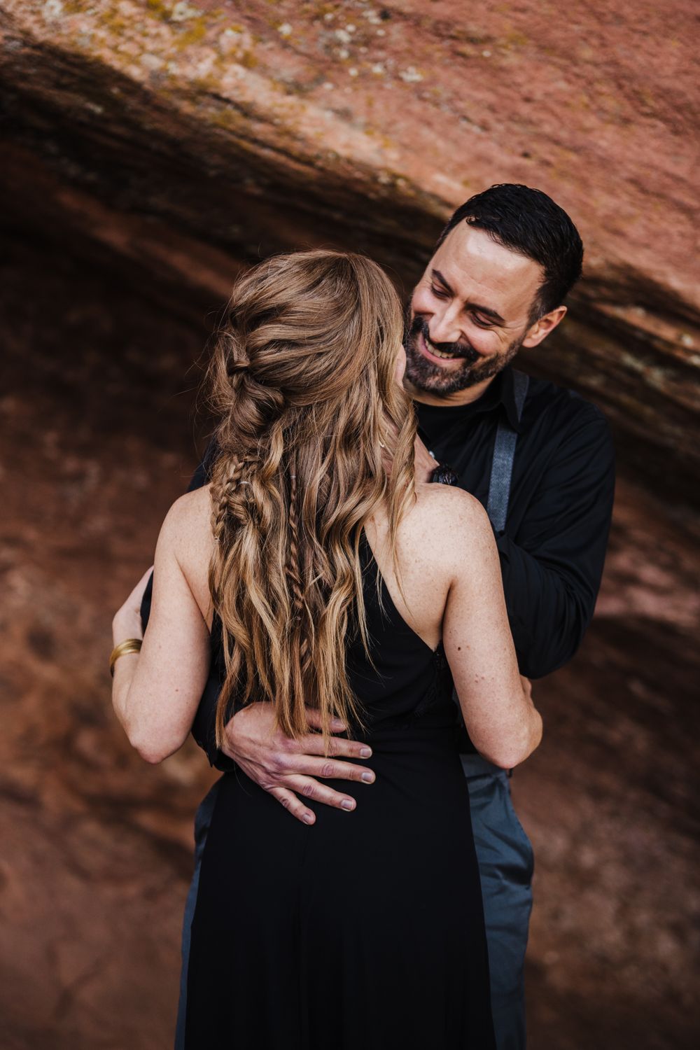 Intimate couple's portrait session with red rock formations in the background.
