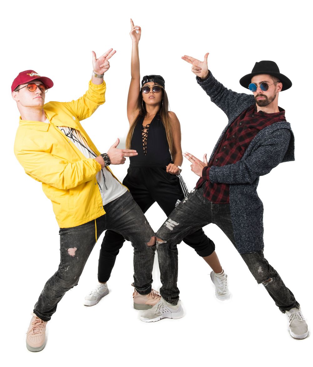 Hip hop dance crew strikes energetic poses in street style outfits.