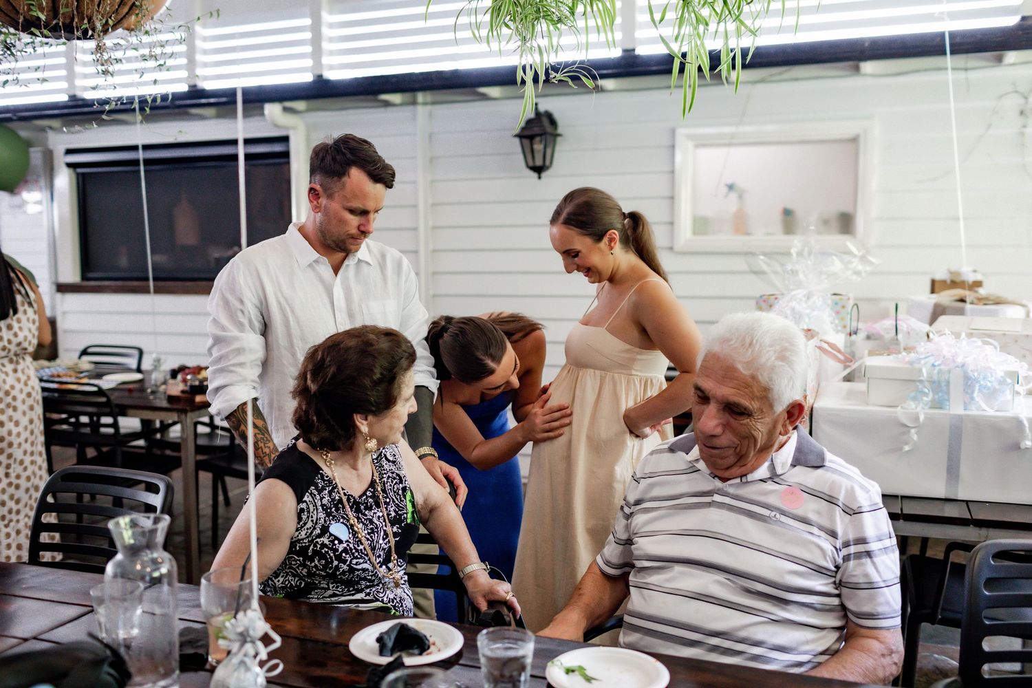 Casual gathering of guests enjoying a celebration meal outdoors.