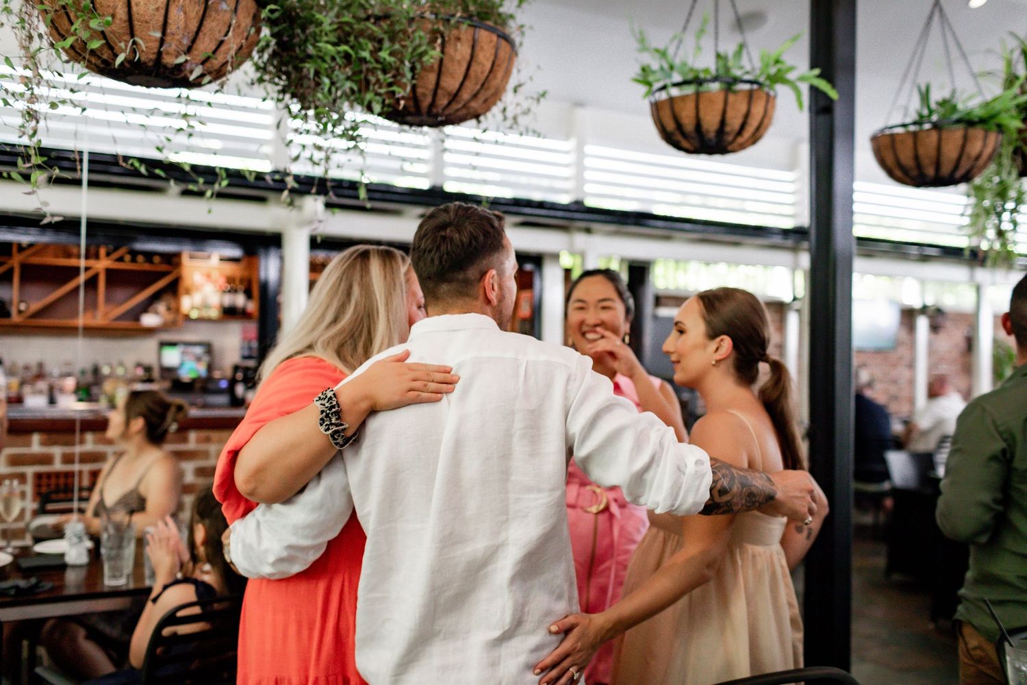 Group of friends sharing laughs at an outdoor celebration.