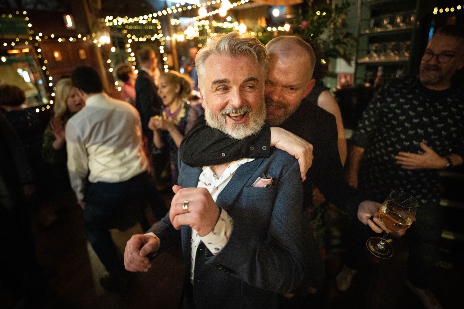 Two Grooms embrace on the dance floor at the Prince Albert Pub in Camden, LGBTQ Wedding hero image