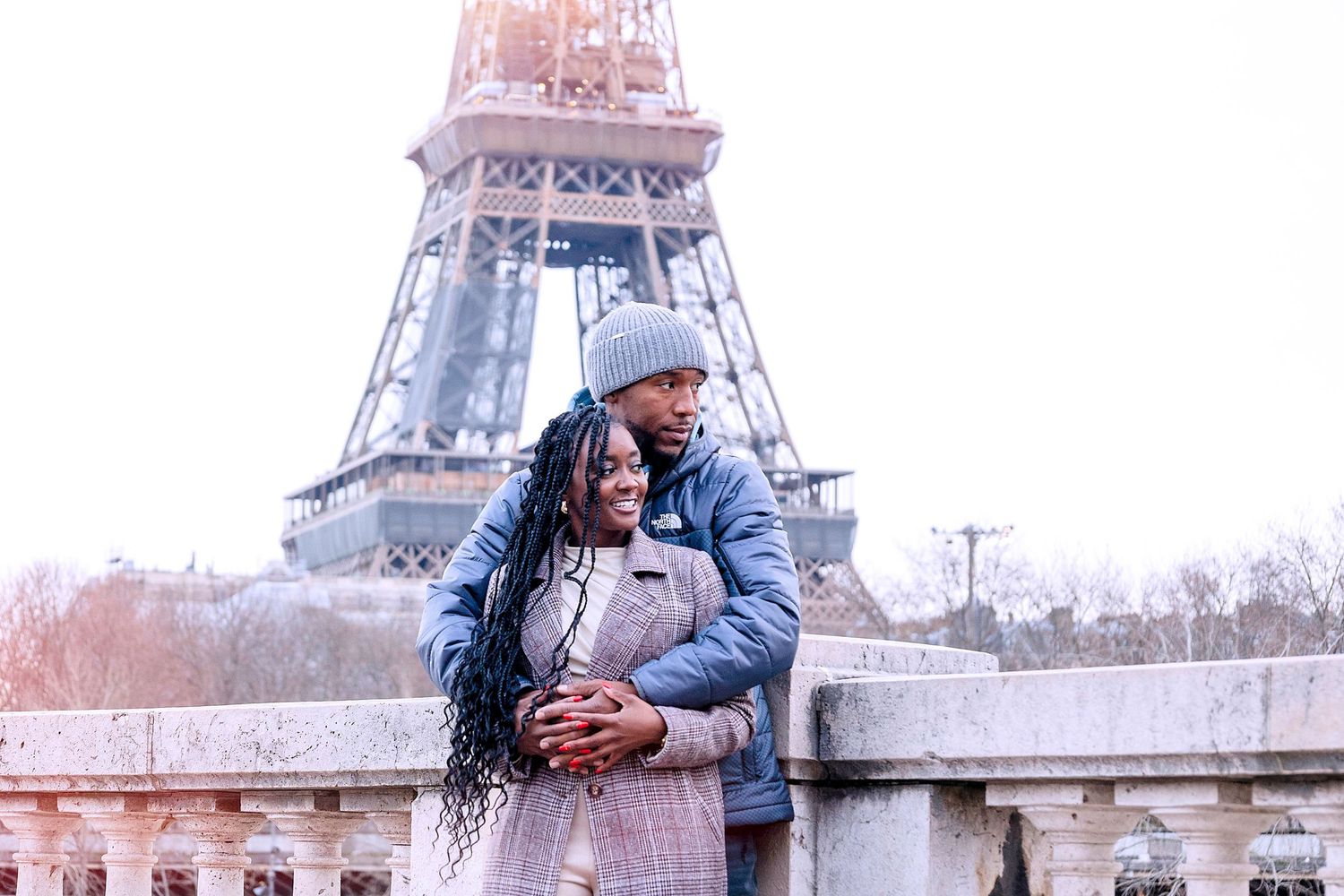 Black couple cudding in front of Eiffel Tower