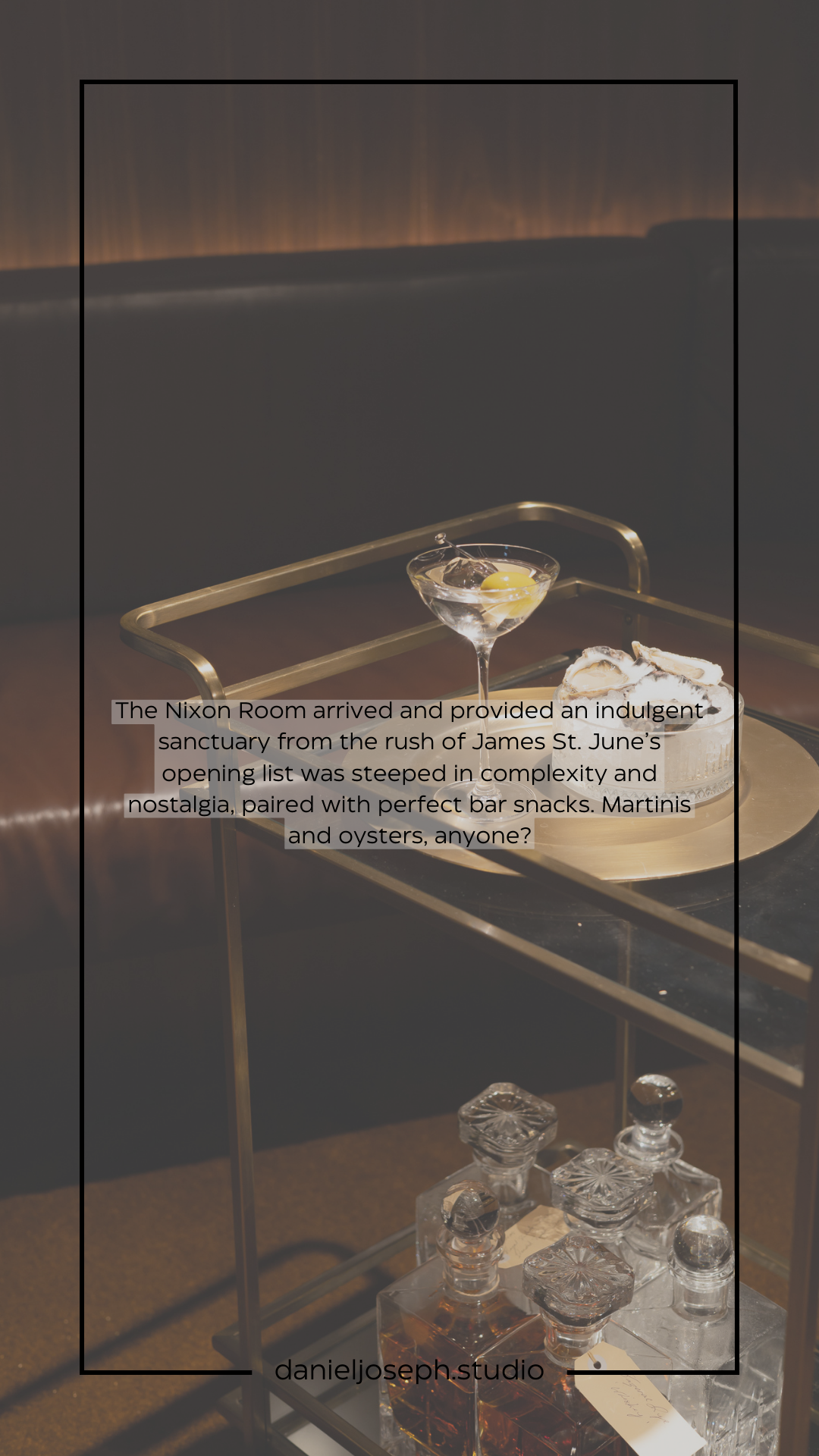 Elegant martini glass and bar setup on a dark table with moody lighting.
