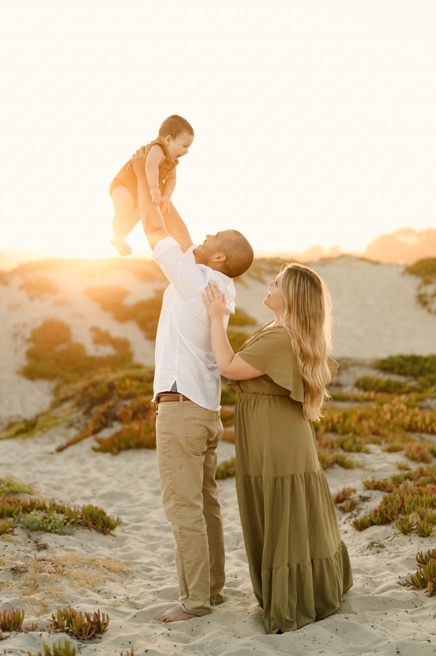 family beach photos by best Santa Barbara family photographer of young family at Coronado Beach during sunset