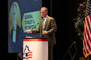 Decorated retired General, keynote speaker addressing a large audience